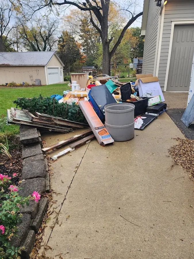 Dumpster being loaded with debris for Commercial Dumpster Rental in Spanish Fort